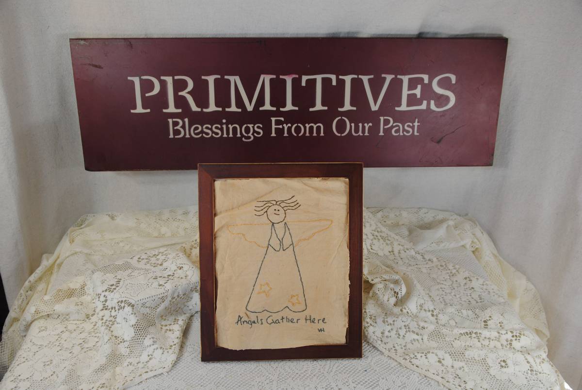 Metal wall sign 30"W X 10"T , along with a wood-framed, hand embroide